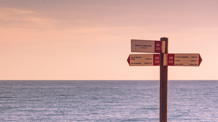 Seascape with wooden signpost