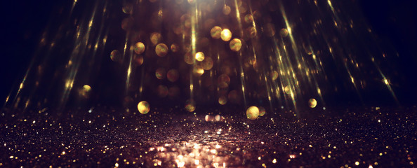 background of abstract glitter lights. gold and black. de focused. banner