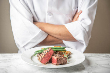chef serving a plate of tenderloin steak