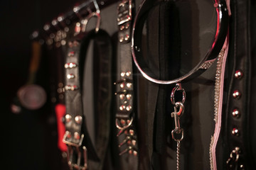 Whips for BDSM on a dark background. Accessory for sexual games.