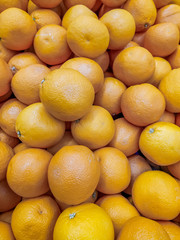 Lots of oranges . Background oranges . Fruit on the counter of the store. Huge selection of oranges.