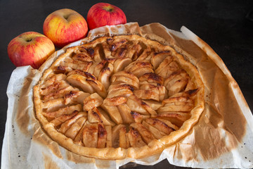 Apple tart and three apples