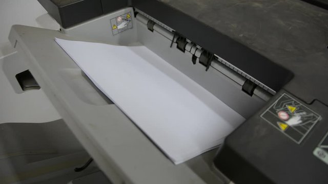 Office printer at work. Sheets of paper in a copier.
