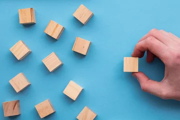 Fotobehang Hand choosing a wooden block from a set. Business choice concept © ink drop