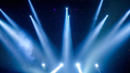 Many stage projectors in the dark Blue spotlight penetrates the darkness