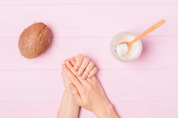 Female hands apply cosmetic coconut oil