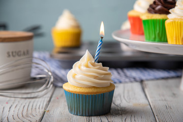 cupcale in colorful paper cup with birthday candle
