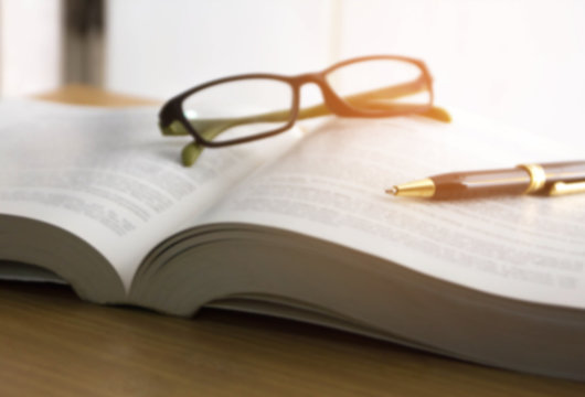 blur image of book ,glasses and pen , reading for the exam concept Stock  Photo | Adobe Stock