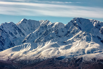 Fototapeta na wymiar Crispy scenic view of snowy mountain peaks in Altai mountains, Russia. Fall 2019