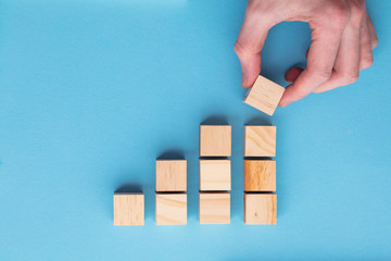 Hand choosing a wooden block from a set. Business choice concept