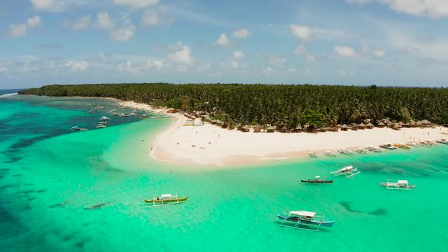 Seascape with beautiful beach and tropical island palm trees by coral reef from above. Daco island, Philippines. Summer and travel vacation concept