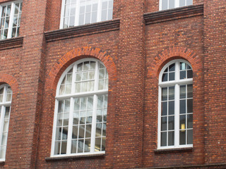 White Arch Windows In A Brick Building