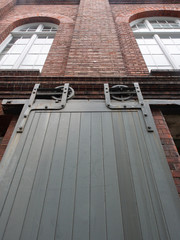 Solid Heavy Door In A Brick Building