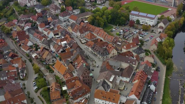 Aerial view of the city  Gernsbach in Germany on a cloudy day in autumn, fall. Tilt up from the old town.