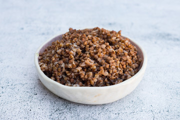 Cooked buckwheat in bowl on table.