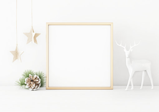 Square christmas poster mockup with golden frame, pine cone, star garland and deer on white wall background. 3D rendering, illustration.