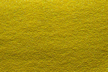A texture of a highly coarse grit sandpaper
