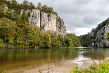 Danube river at Danube breakthrough near Kelheim, Bavaria, Germany in autumn with limestone rock...