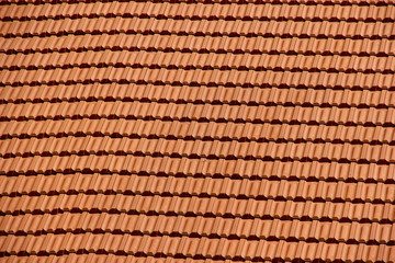 Texture of a roof tiled with new clean plastic tiles