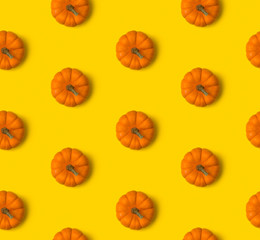 Autumn seamless pattern. Pumpkins on yellow background