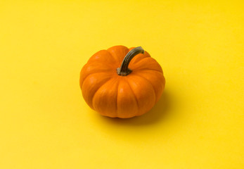Autumn composition. Pumpkin on yellow background. Top view