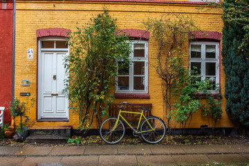 Fototapeta na wymiar yellow bicycle and old house