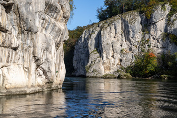 Danube river breakthrough near Kelheim, Bavaria, Germany in autumn with limestone rock formations and clear water on a sunny day at autumn month october