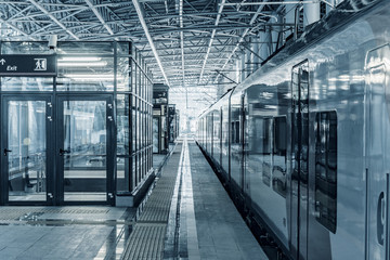 Passenger train stands by the platform before departure.