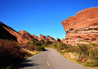 Road Winding Through Red Rock Formations in Mountains of American Wild West