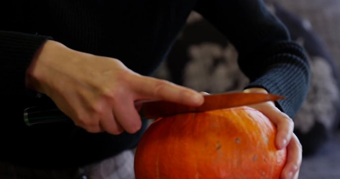Beautiful asian woman carving a pumpkin for Halloween, creative hobby for fun