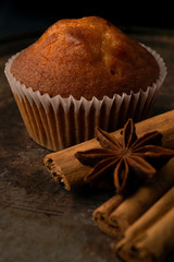 muffin with cinnamon stick on dark background