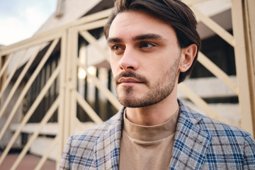 Portrait of young handsome man intently looking away outdoor