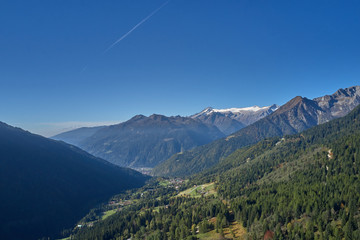 Autumn season, red-yellow trees. Aerial photography. Panoramic view of the Alps north of Italy. Trento Region. Great trip to the Alps.