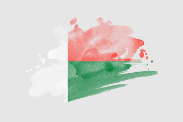 National flag of Madagascar. Stylized flag with watercolor halftone effect on plain background