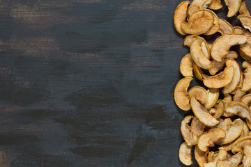 Fototapeta premium Flat lay with dried apple on the brown background
