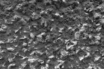 Texture of sharp and rough stone wall, random pattern background with sunlight.