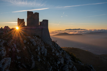 Ruins of medieval castle of Rocca Calascio at sunny morning, with foggy landscape in background and...