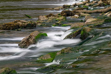 River Meavy water flowing over rocks at Lopwell Weir, Plymouth, Devon