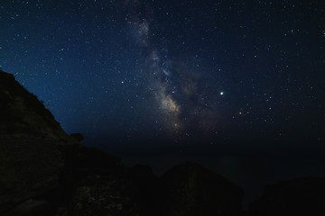 Starry sky at night on the sea coast