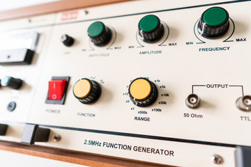 Analog function generator table in electronic laboratory class at college, old school student lab...