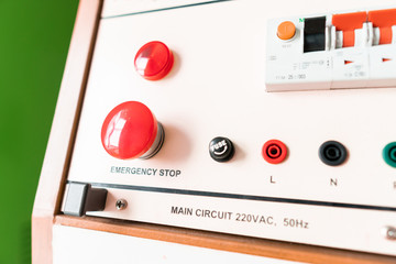 Emergency stop button on analog function generator table in electronic laboratory class at college,circuit breaker old school student lab equipment