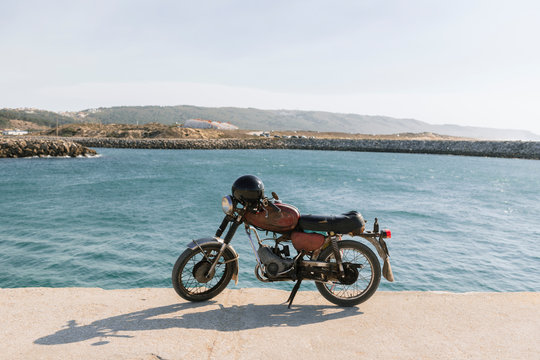 View of old motorcycle on the sea shore, Nazare, Portugal