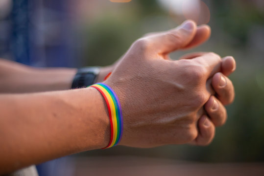 Man hands with gay flag bracelet