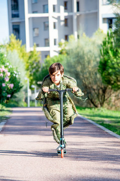 Boy wearing a space suit on scooter