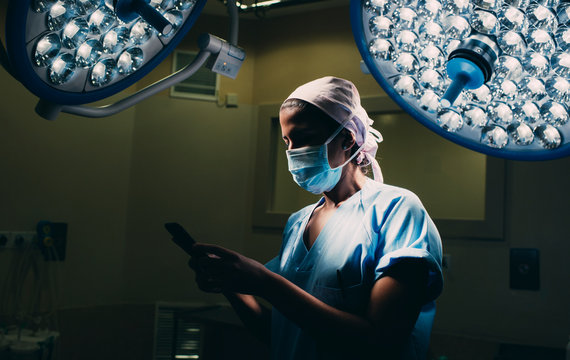 Nurse using a mobile phone in operating room