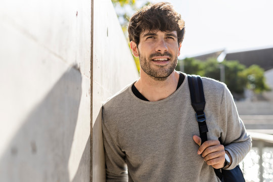 Man with backpack having a break in the city