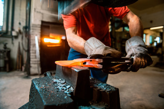 Senior blacksmith working in hammer mill