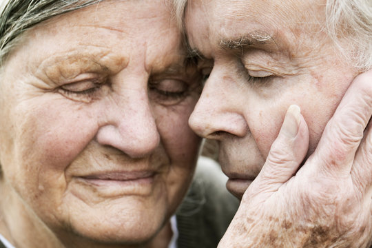 Portrait of senior couple head to head with closed eyes