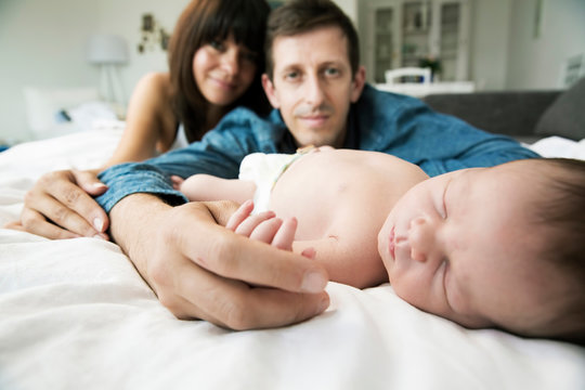 Young parents with her newborn son at home