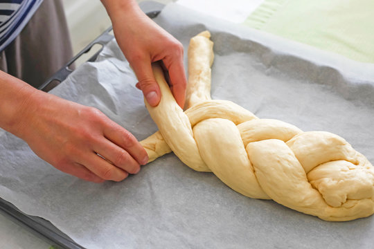 Germany, braiding a braided yeast bun